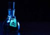 Dark bottle with skull and crossbones label on table
