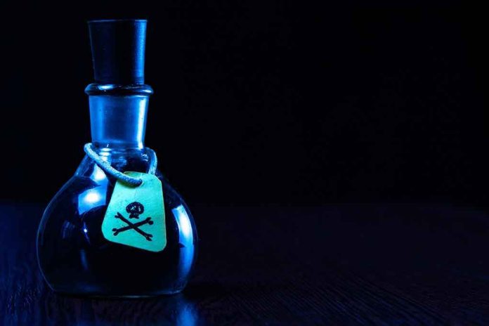 1946359798 Dark bottle with skull and crossbones label on table