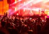 Crowd at concert with vibrant stage lights