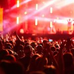 Crowd at concert with vibrant stage lights