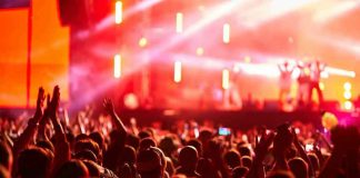 Crowd at concert with vibrant stage lights