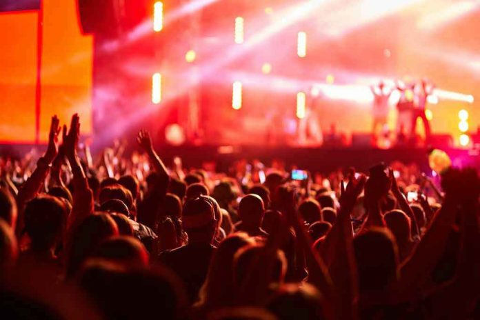 2454781497 Crowd at concert with vibrant stage lights