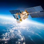 Satellite orbiting Earth with moon in background