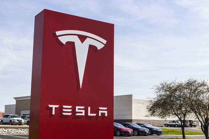 620657588 Tesla sign in front of dealership
