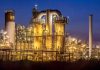 An industrial facility with illuminated structures at night