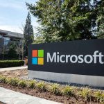 Microsoft sign with office buildings and trees