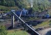 Industrial coal processing plant with conveyor belts and smokestack