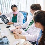 Doctors discussing chest X ray results at a workstation