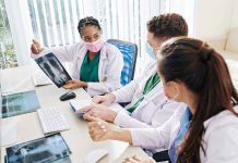 Doctors discussing chest X ray results at a workstation