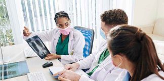 Doctors discussing chest X ray results at a workstation