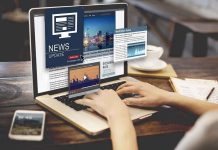 Person reading news websites on a laptop
