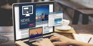 Person reading news websites on a laptop