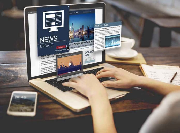 Person reading news websites on a laptop