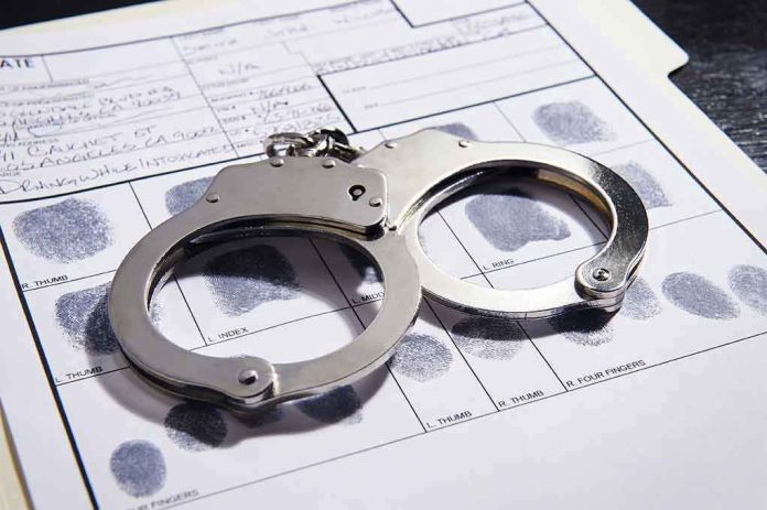 Handcuffs on fingerprint form with fingerprints visible