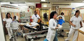 Medical staff attending to patients in a busy hospital emergency room