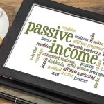 Word cloud on a tablet displaying terms related to passive income