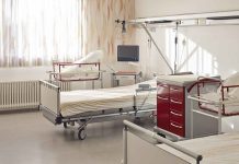 A hospital room featuring empty patient beds and medical equipment