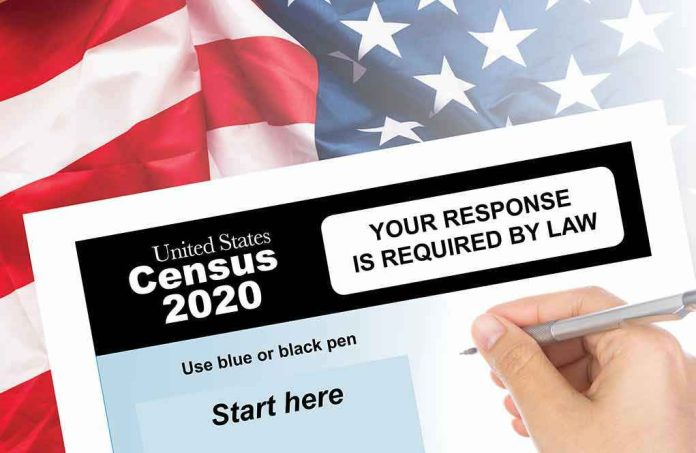 1468847699 Hand filling out the U.S. Census 2020 form