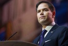 Man in suit speaking at podium