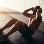 Man performing sit ups in a gym setting