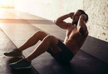 Man performing sit ups in a gym setting
