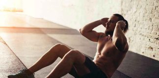 Man performing sit ups in a gym setting