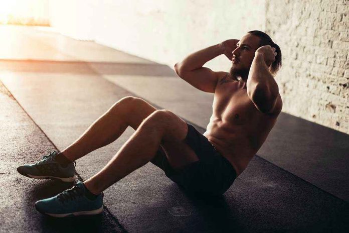 Man performing sit ups in a gym setting