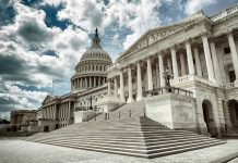 The US Capitol building with a cloudy sky backdrop