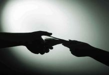 $130 Million Donation Exposes SHOCKING Military Crisis Silhouette of hands exchanging money in dim light