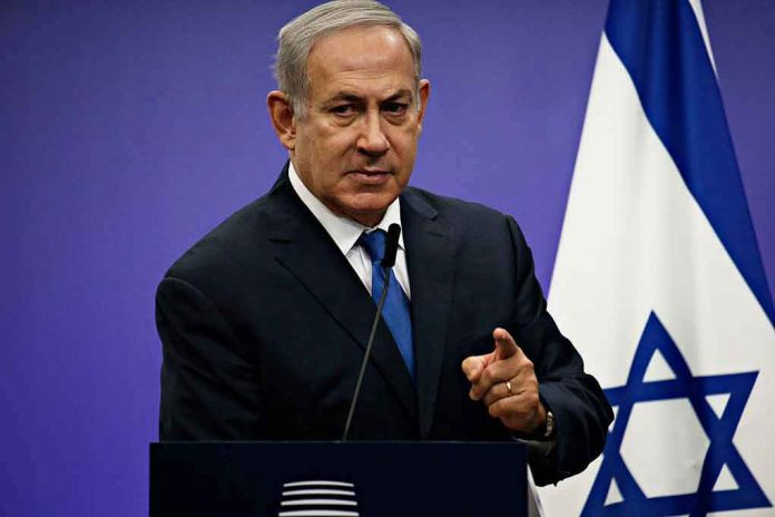 1042782061 Man in suit giving speech in front of Israeli flag