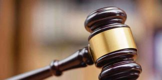 Judges gavel striking a sound block