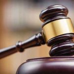 Judges gavel striking a sound block