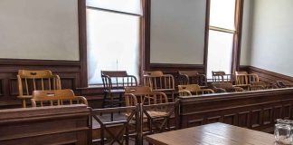 Empty jury box and table in courtroom