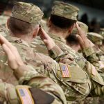 Federal Forces Storm Cities — Legal Chaos Ensues Soldiers in camouflage uniforms saluting in formation outdoors