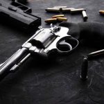 NRA SLAMS Judge—Supreme Court Win IGNORED Revolvers and bullets on a dark surface