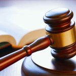 Matriarch’s Murder Conviction SHOCKS Legal World Gavel resting on sounding block beside open book