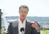 Newsom Caught in ‘Poorigin’ Scandal Man speaking with microphone outdoors