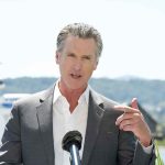 Man speaking with microphone outdoors