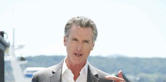 Man speaking with microphone outdoors