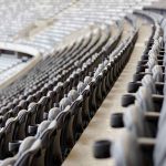 Empty rows of gray seats in a stadium