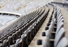 Empty rows of gray seats in a stadium
