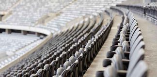 Empty rows of gray seats in a stadium