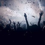 Anti-American Concert Sparks Conservative Outrage Crowd celebrating under confetti and bright lights.