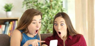 Two women look surprised at a phone