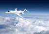 Private jet flying above the clouds