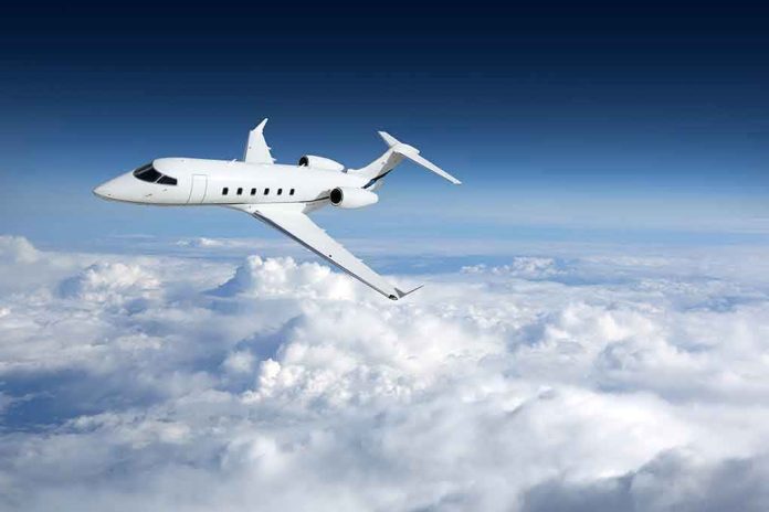 Private jet flying above the clouds