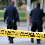 Deadly Swatting Rampage—Cops Missed Every Sign Police officers walking past caution tape at a crime scene