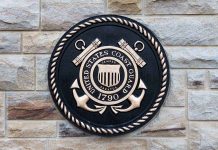 Trump Shocks with Cyber-Savvy Coast Guard Nominee Bronze emblem of the United States Coast Guard mounted on a stone wall