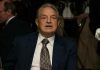 Soros’ $7.6M Protest Plan Backfires Elderly man in a suit sitting at a dining table during a formal event