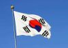 Trump CROWNED By Foreign Nation — UNPRECEDENTED Honor South Korean flag waving against a clear blue sky